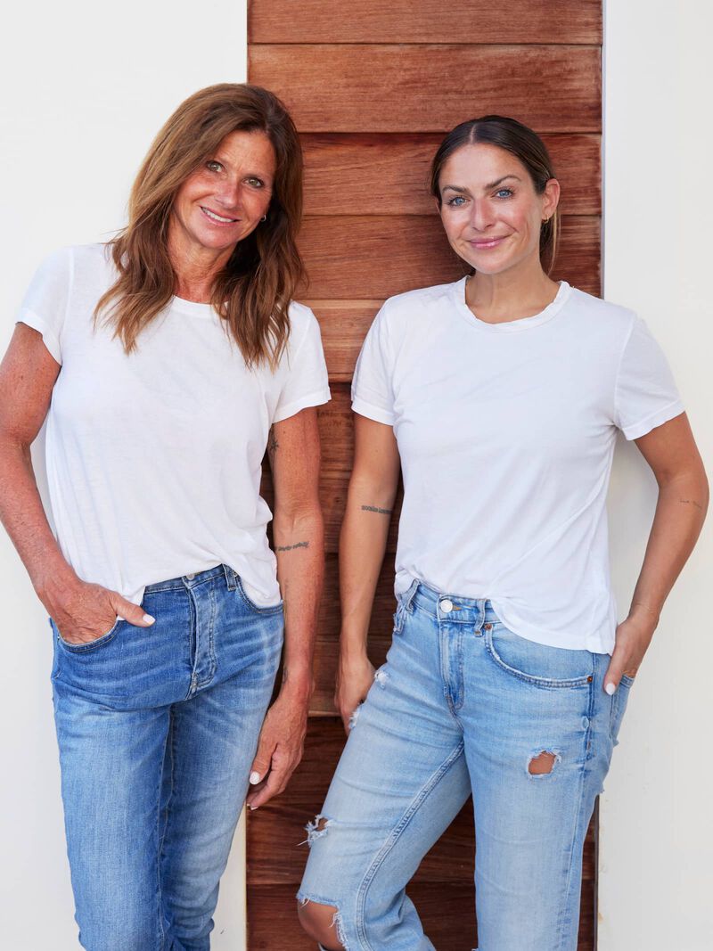 Tif and Kelsey post next to a shiplap wall